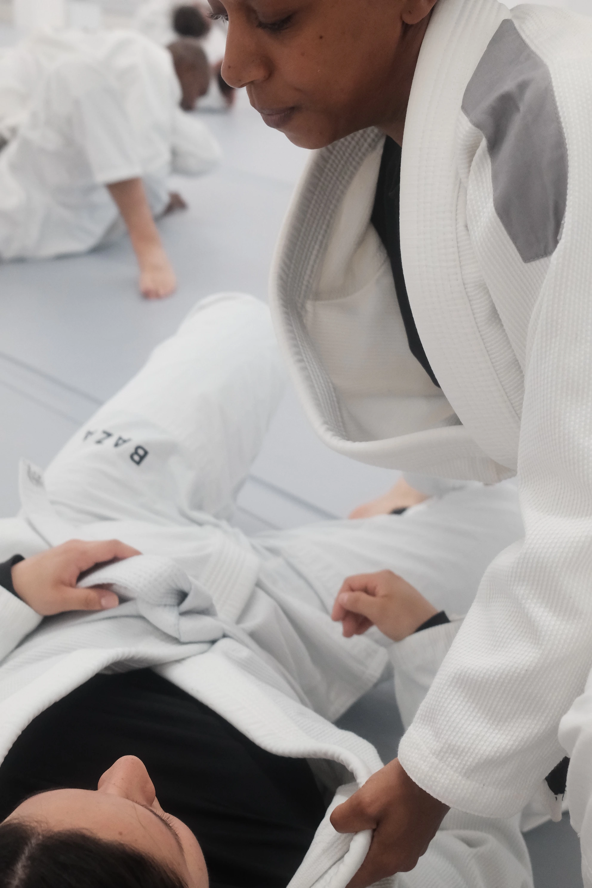 Close-up of youth BJJ training with focused grip work at BAZA academy